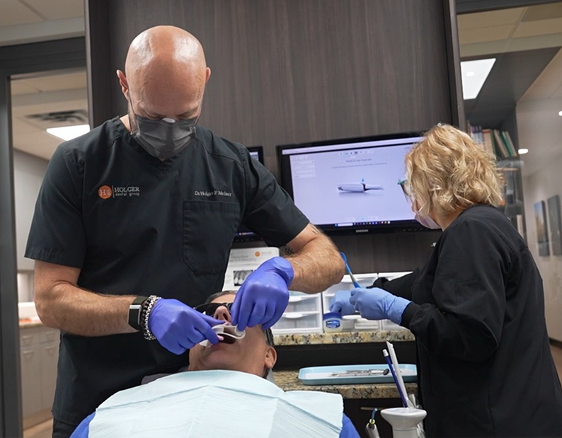 Dentist and assistant treating a patient