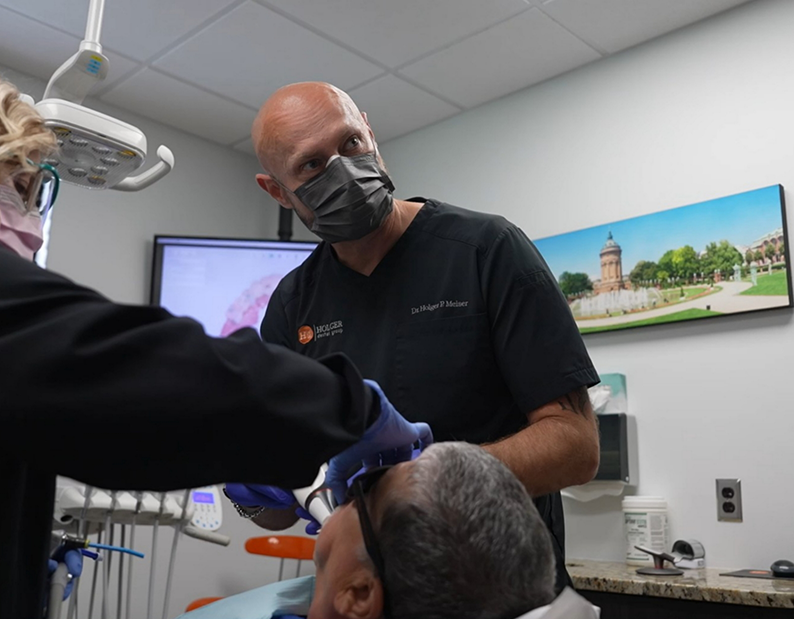 Dentist and assistant performing a procedure on a patient