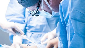 Dental team carefully performing oral surgery