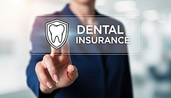 Woman standing behind dental insurance graphic